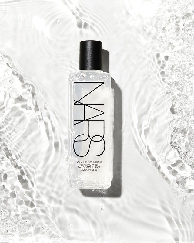 NARS Aqua Infused Makeup Removing Water product shot on white background with water reflections. Beauty, skincare, and studio lighting.