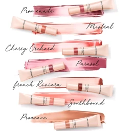 Multiple cosmetic tubes displayed over corresponding blush swatches on a white background with handwritten shade names.