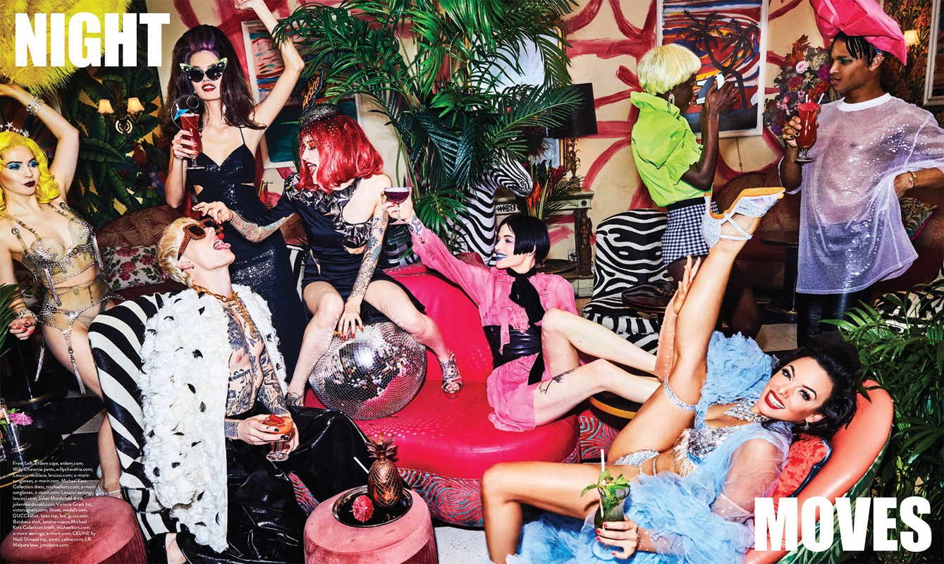 Editorial fashion shot of a group of diverse young adult models in retro-style clothing, posing together in a decorated indoor setting with props.