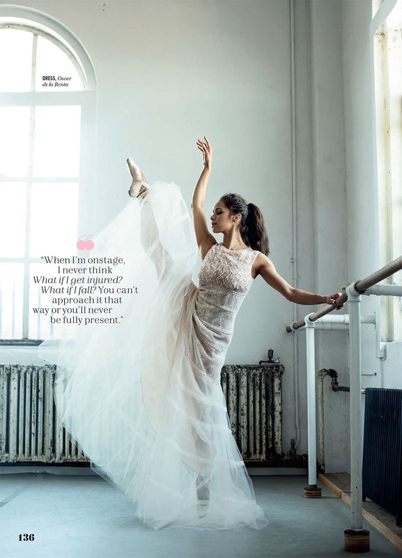 Elegant photo of a ballerina in a white dress striking a graceful pose in a dance studio. The image captures movement and artistry.