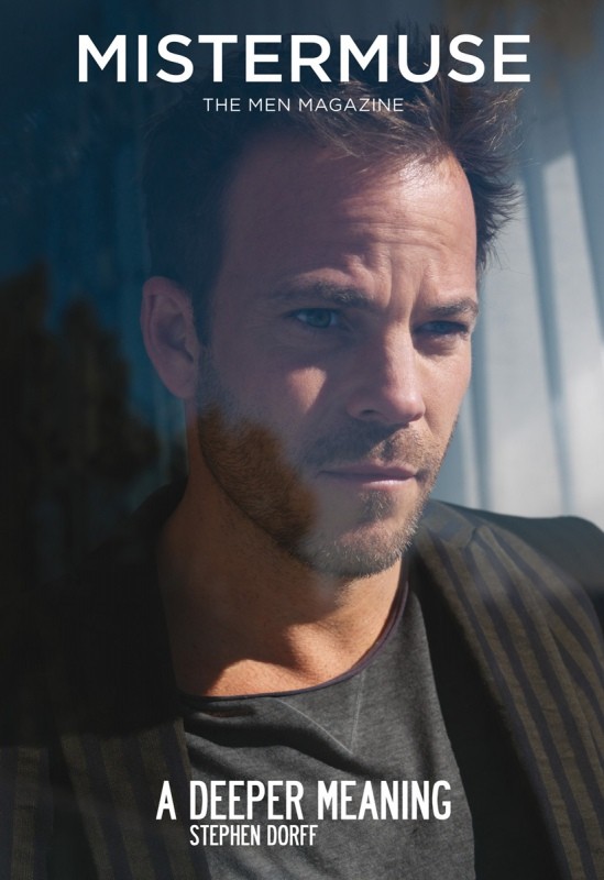 Close-up of Stephen Dorff on magazine cover. Man in grey shirt and dark jacket poses with slight smile, blue and grey background.