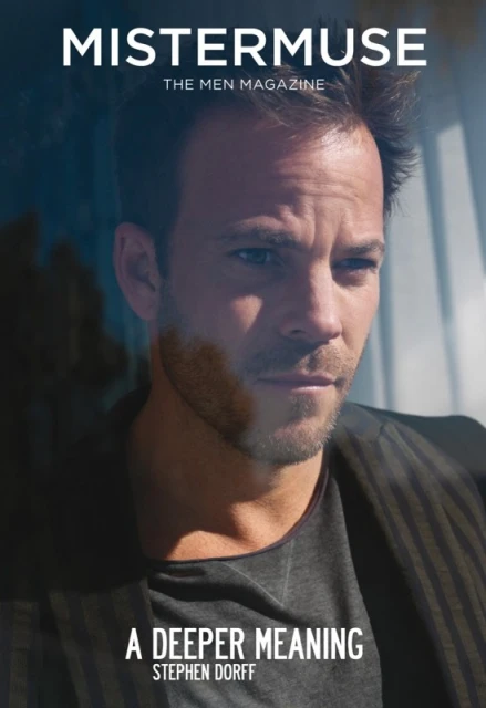 Close-up of Stephen Dorff on magazine cover. Man in grey shirt and dark jacket poses with slight smile, blue and grey background.