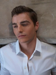 Portrait of Dave Franco wearing a white button-down shirt against a neutral textured background, photographed by Mona Kuhn.