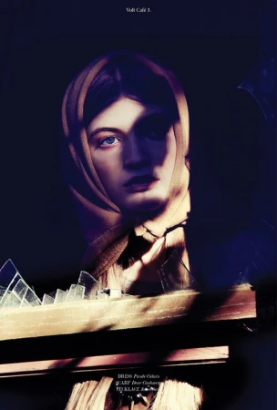Portrait of a woman wearing a headscarf, framed by shattered glass and a dark background in a high-fashion editorial style.