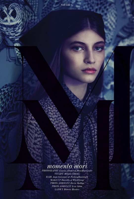 Fashion portrait of a young woman with dark hair and hat, textured clothing, against an owl-patterned background with large sans-serif type overlay.