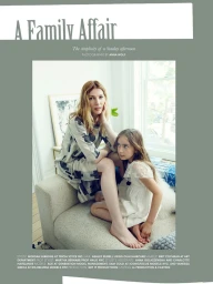 Woman in patterned dress seated on a sofa with a child styled by Morgan Gibbons