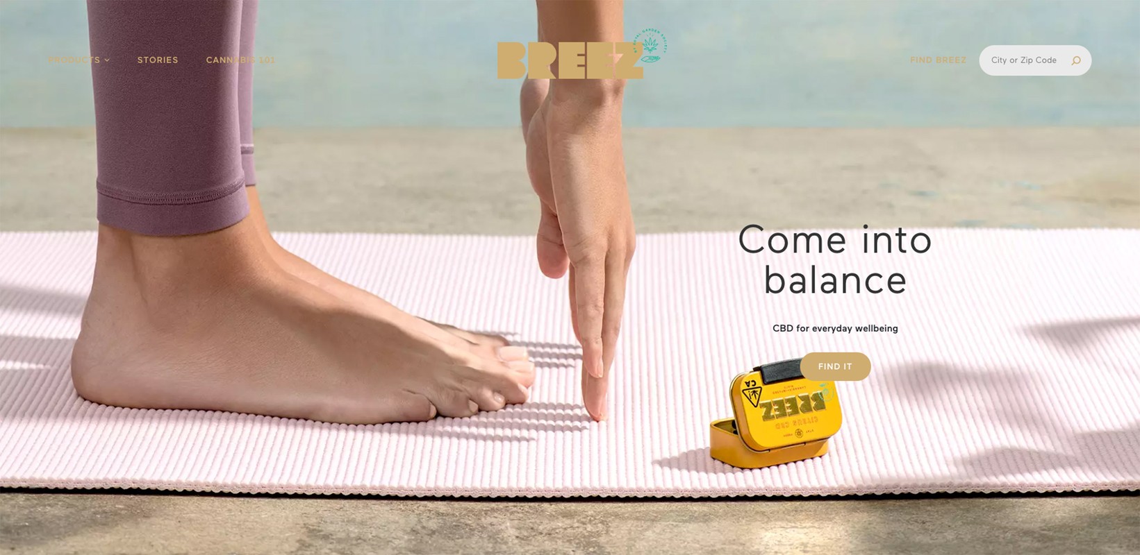 Person reaching down toward a yellow CBD container on a pink yoga mat indoors; Breez logo and product promotion with wellness theme.