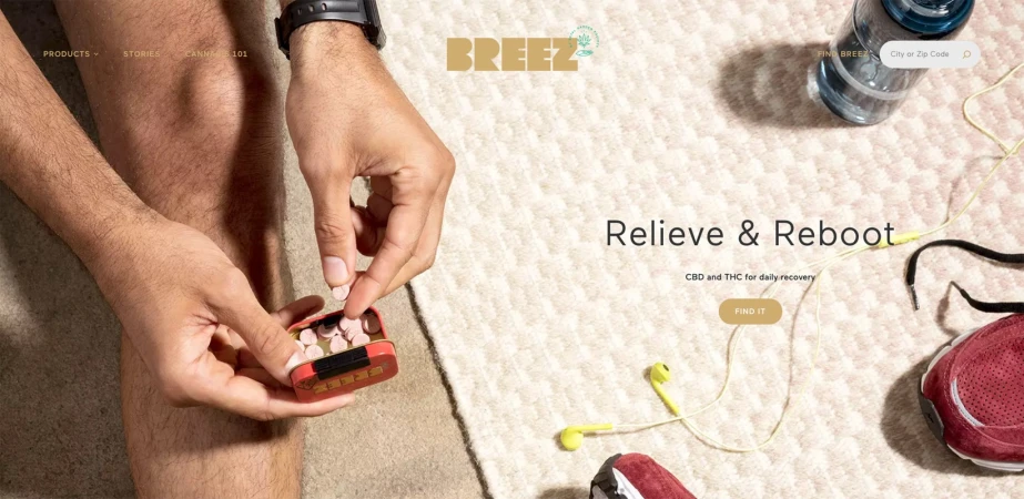Person holding pills, bottle of water, running shoe, and ear buds on a textured surface. CBD wellness concept image for Breez brand.
