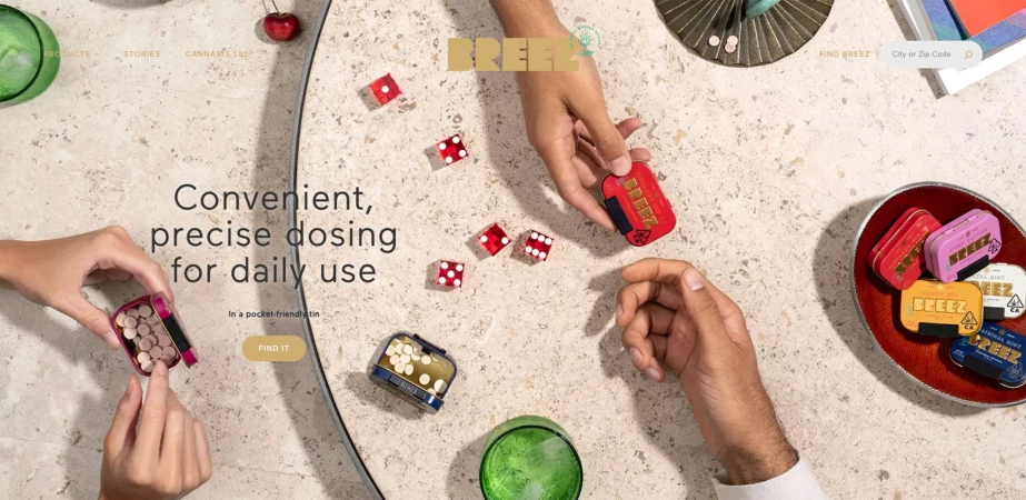Overhead shot of hands interacting with colorful BREEZ mint tins and dice, arranged on a speckled surface, with brand-related text.
