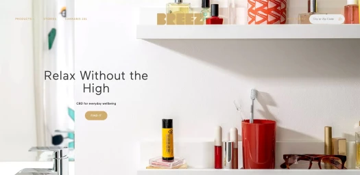 Website interface screenshot showing white bathroom shelves with toiletries, a red toothbrush holder, and typography