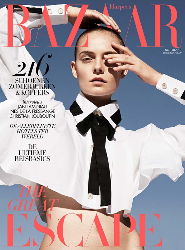 Magazine cover of Harper's Bazaar featuring a model with a buzzcut wearing a white collared shirt with a black bow against a blue sky.