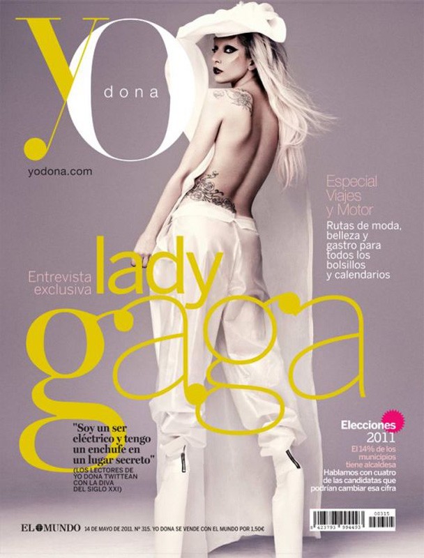 Magazine cover featuring Lady Gaga in white outfit, showcasing fashion, celebrity, and entertainment themes with a grey background.