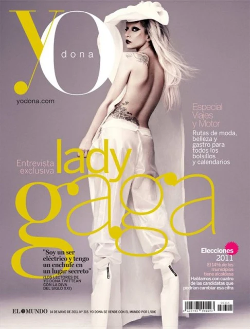 Magazine cover featuring Lady Gaga in white outfit, showcasing fashion, celebrity, and entertainment themes with a grey background.