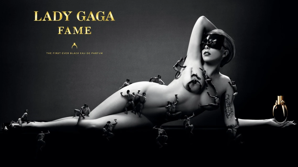 Lady Gaga reclines holding a perfume bottle, covered by tiny people in a black and gray ad, with gold text on a black background.