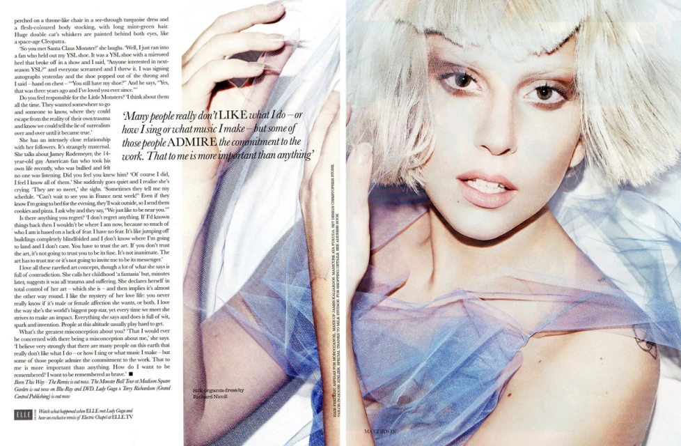Editorial shot of fair-skinned adult female model with blonde hair, light eye makeup, and light pink lipstick, wearing a light blue tulle dress.