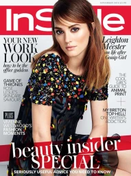 Leighton Meester on the cover of InStyle magazine wearing a dark patterned dress with multi-colored embellishments.