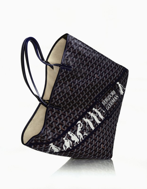 Dark monogram tote bag with double top handles and white printed silhouettes against a clean white seamless studio background.