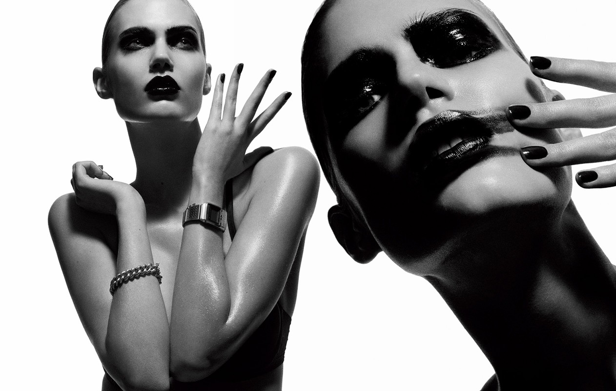 Monochrome portrait of a woman with dark lipstick posing against a white background by photographer Philippe Salomon.