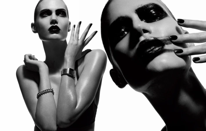 Monochrome portrait of a woman with dark lipstick posing against a white background by photographer Philippe Salomon.