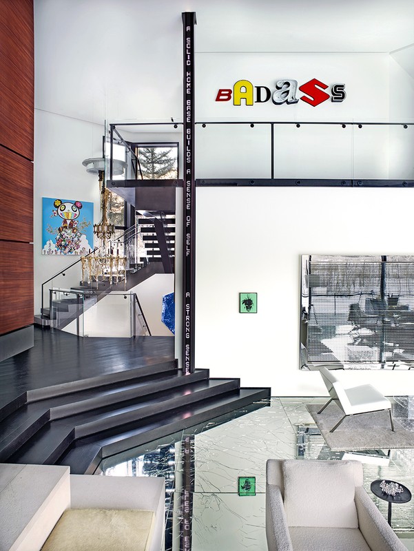 Modern home interior with statement staircase, art pieces, and contemporary furniture, showcasing a stylish and open living space.