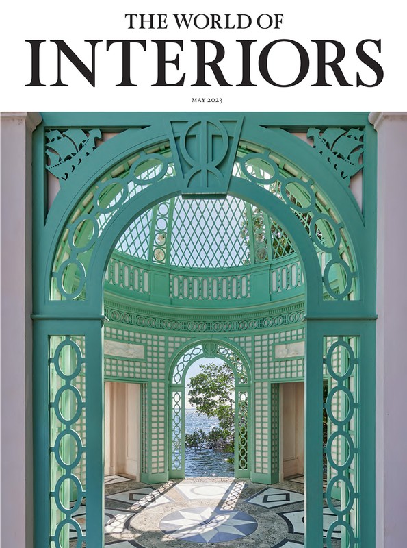 Magazine cover of The World of Interiors featuring a teal architectural structure framing a view of water and sky.