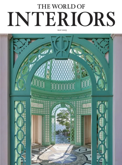 Magazine cover of The World of Interiors featuring a teal architectural structure framing a view of water and sky.