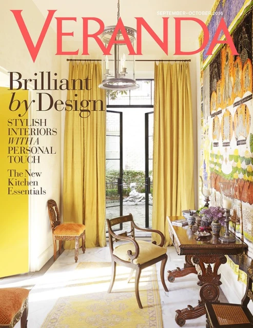 Veranda magazine cover featuring an interior design with yellow curtains, a wooden desk and chairs, and an outdoor view.