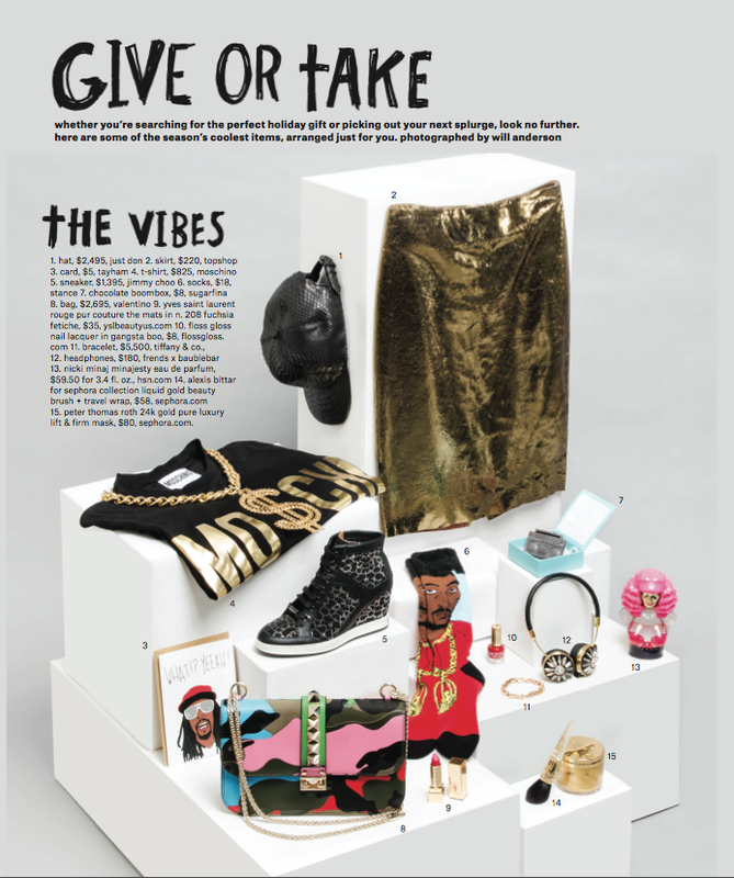 Arrangement of various fashion and beauty items on white platforms, including a hat, skirt, shirt, card, sneakers, and accessories.