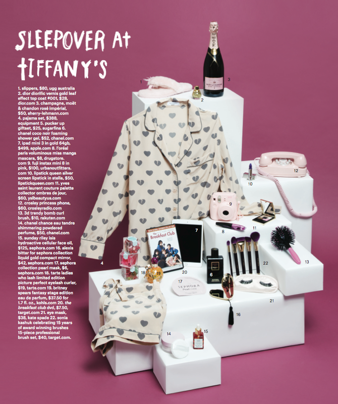 Still life of various beauty and sleepover-themed products, including pajamas, cosmetics, and a telephone, all arranged on white blocks.