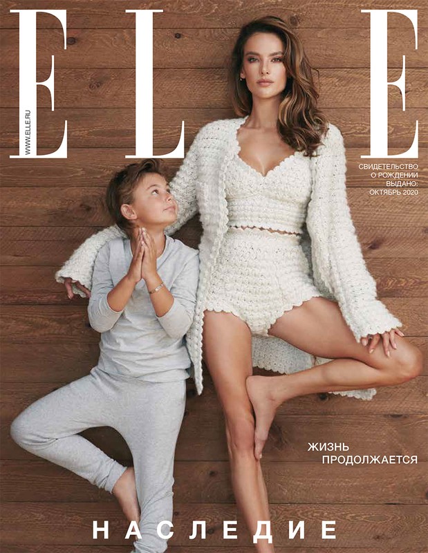 Elle Magazine cover featuring a barefoot adult female model and a child wearing matching knitwear and loungewear, respectively, against a wood backdrop.