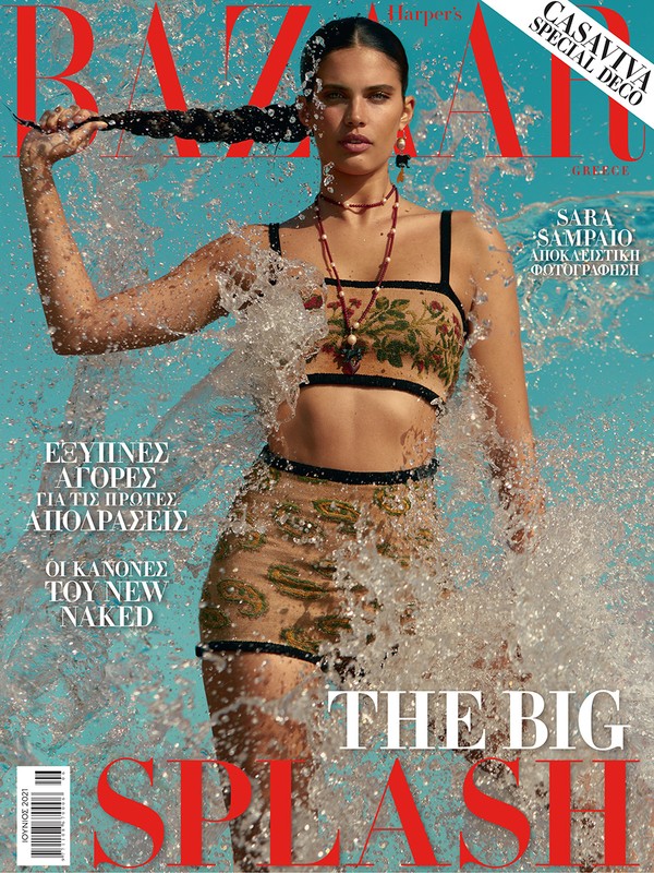 Magazine cover featuring Sara Sampaio in water, wearing a bikini-style outfit with floral accents against a light blue background.