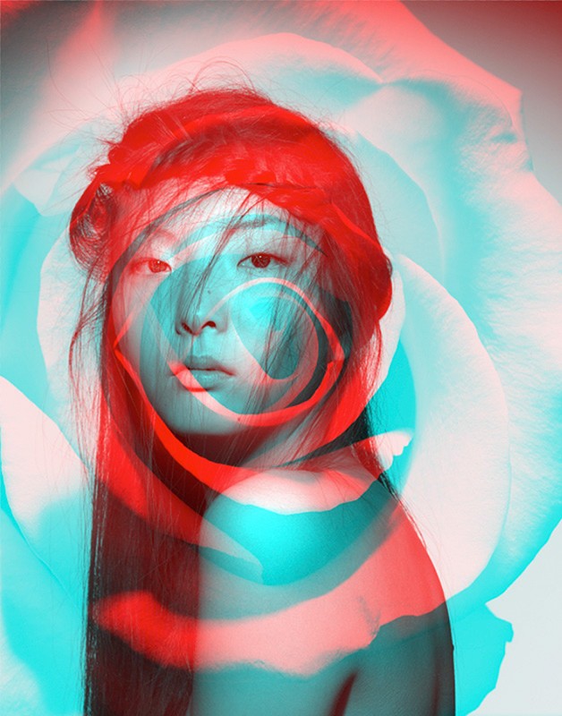 Portrait of a young woman with an overlapping red and blue color effect, creating a surreal and artistic photograph with flower in background.