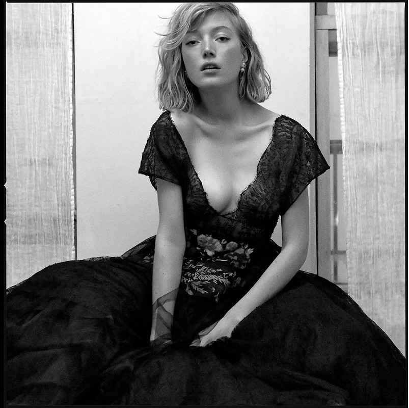 Portrait of a woman wearing a dark lace dress with floral embroidery, styled with hair by Rebecca Plymate in Los Angeles.
