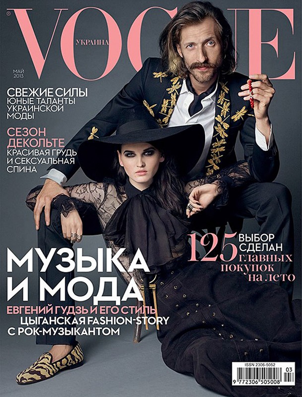Vogue Ukraine magazine cover featuring a stylish man in an embellished blazer and a woman in a wide-brimmed hat and lace top.