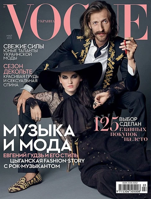 Vogue Ukraine magazine cover featuring a stylish man in an embellished blazer and a woman in a wide-brimmed hat and lace top.