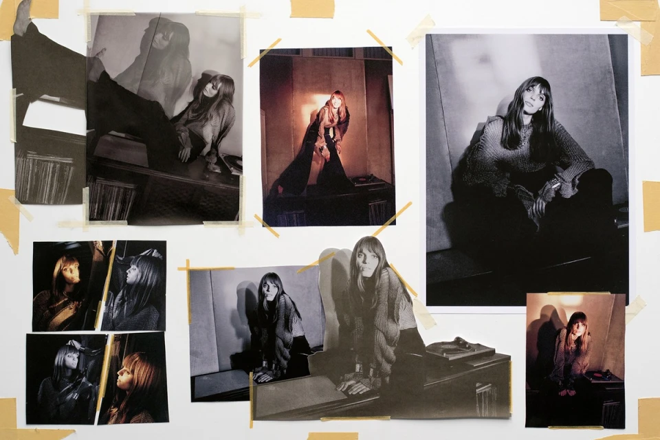 Arrangement of photographs showing a female model posing in a photo studio, attached to a white wall with yellow tape.