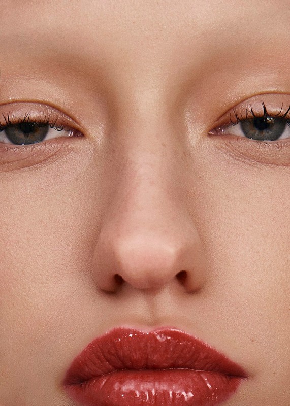 Close-up portrait of a model featuring glossy red lipstick and subtle makeup artistry by Roberto Alvarado Jr in Los Angeles