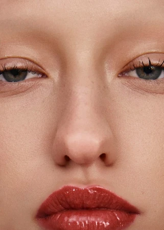 Close-up portrait of a model featuring glossy red lipstick and subtle makeup artistry by Roberto Alvarado Jr in Los Angeles