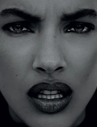 Extreme close-up portrait of a model with dark eye makeup and textured lips by Roberto Alvarado Jr in Los Angeles