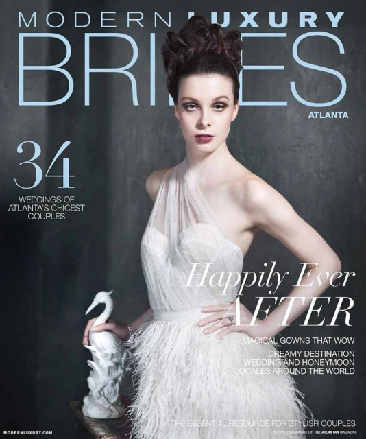 Magazine cover featuring a woman in a white wedding dress holding a white sculpture against a muted grey backdrop. Bridal fashion.