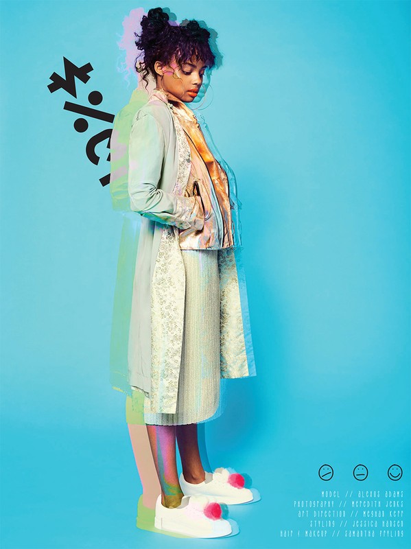 Full shot of a Black woman in a pastel jacket and skirt, wearing white platform shoes in a blue studio with graphical elements.