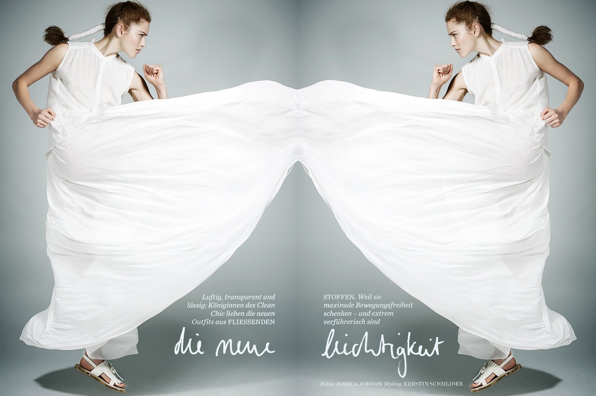 Fashion shot of two young women with flowing white dresses and sandals. The models are mirror images against a gradient grey background.