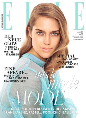 Model with long blonde hair and blue eyes wearing a sheer turquoise top on magazine cover