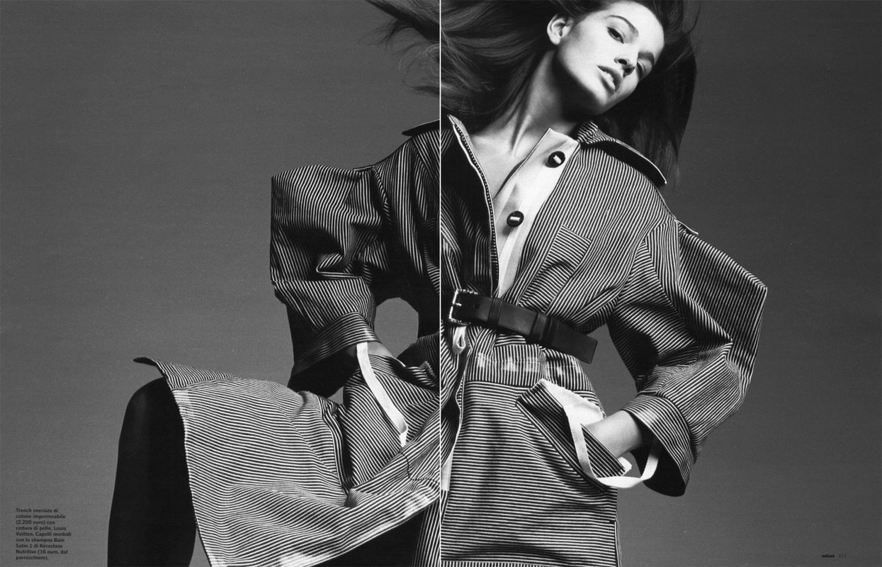Black and white editorial portrait of a woman wearing a striped belted trench coat by photographer Sarra Na.