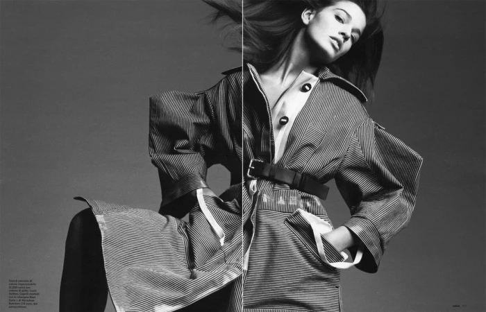 Black and white editorial portrait of a woman wearing a striped belted trench coat by photographer Sarra Na.