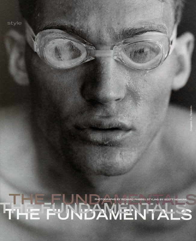 Black and white studio portrait of a male swimmer wearing goggles, water droplets on face, and typography overlay.  