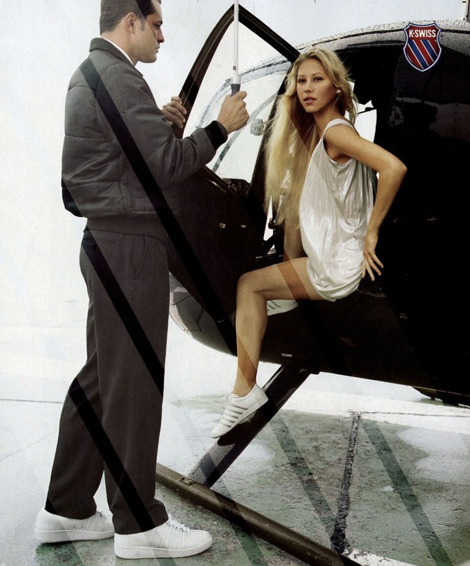 Woman in silver dress exiting a helicopter, man holding umbrella, white sneakers, K-Swiss logo, studio lighting, fashion editorial.