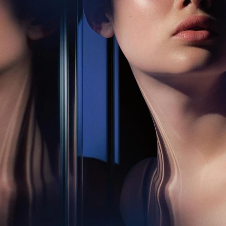 Close-up portrait of a woman's lower face and neck reflected in mirrors with dramatic directional lighting and blue tones