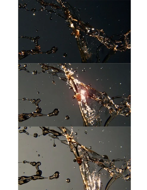 Water suspended in motion catches light. Liquid droplets and strands display dynamic movement against changing grey and black backgrounds.