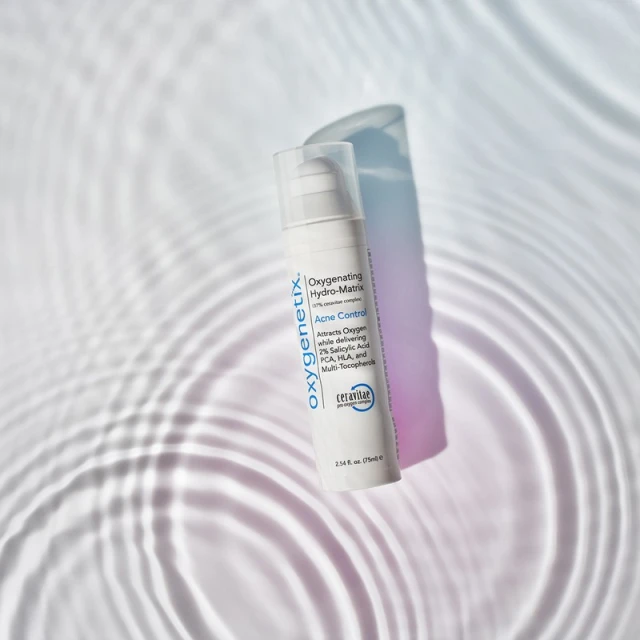 Oxygenetix Acne Control product with a soft shadow, set against a background of rippling light and shadow patterns.